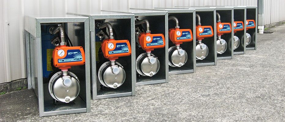 pioneer-township-skan-healthshield-3 Line up of 9 water water filtration systems outside a building