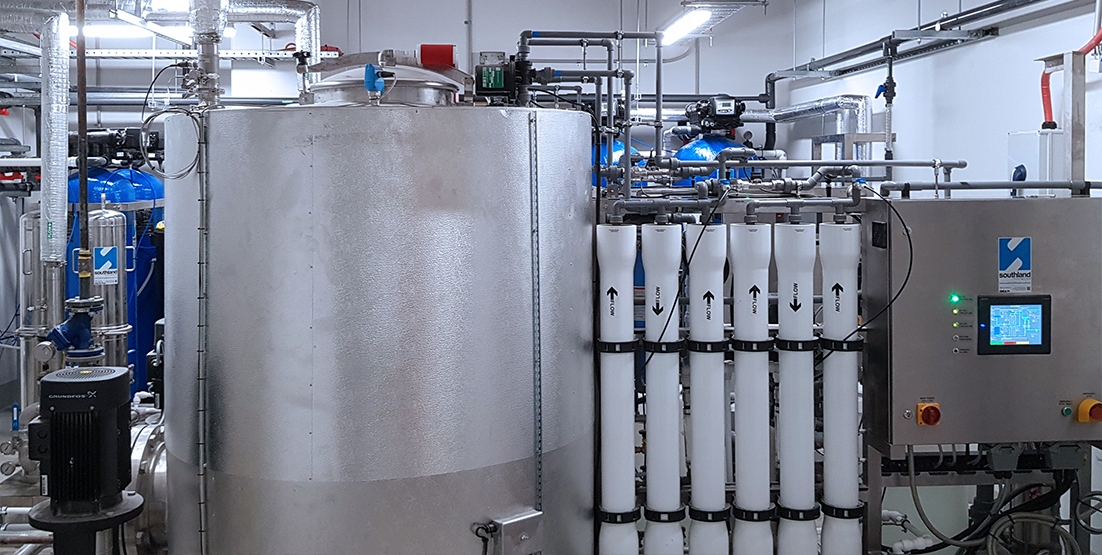 Photo of steel tank, filters & control panel of water filtration system in plant room of hospital