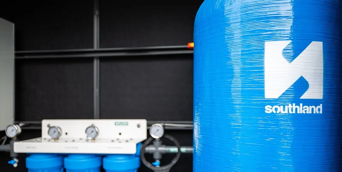 hunter water potable water installation 2 Large scale water tank in foreground, with filtration system against a wall blurred in background