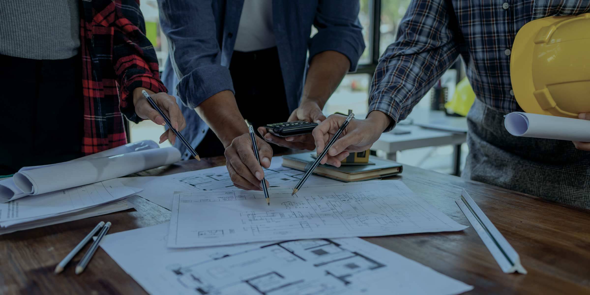 RO compliance in hospitals Engineers using paper plans on a table.