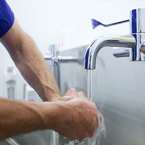 man washing hands with potable water