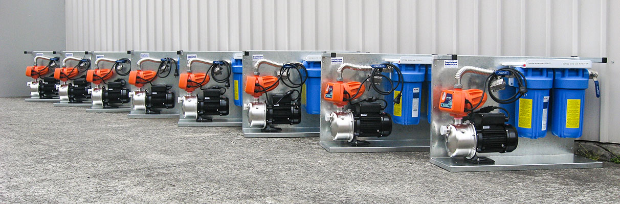 a line up of 8 water filtration systems outside