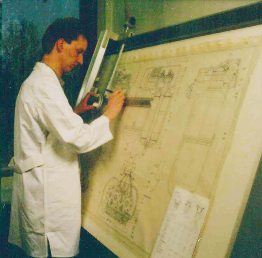 Man drawing at a draft board.