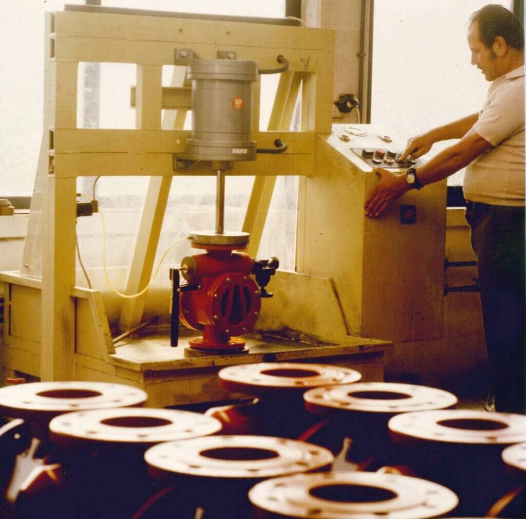 Man standing at a machine working.