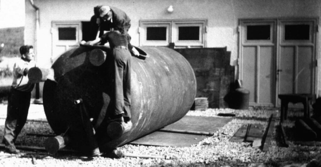 Old photo of men cleaning a boiler